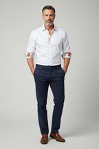 Model wearing white shirt with floral cuffs - front view